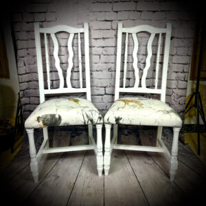 2 white 'elephant' print chairs